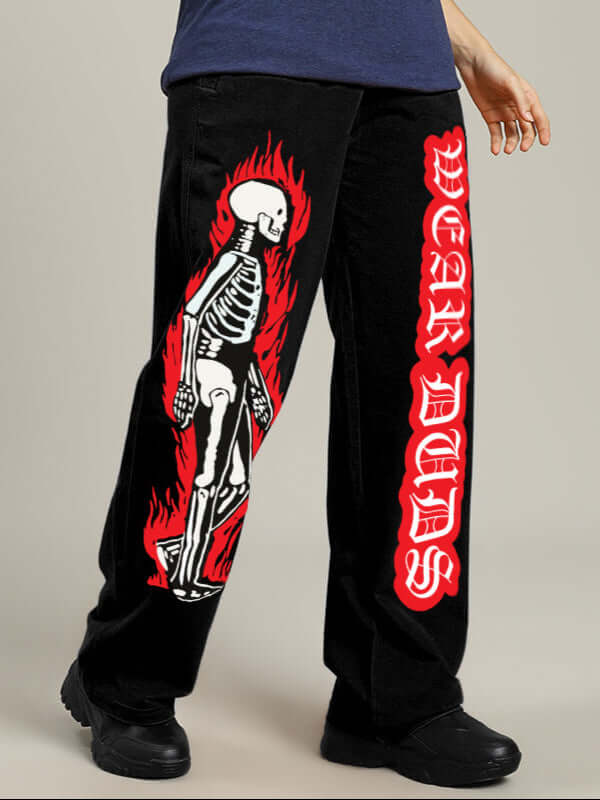 Women's relaxed fit jogger in black featuring a vibrant flaming skeleton print and bold red lettering, custom fit options available.