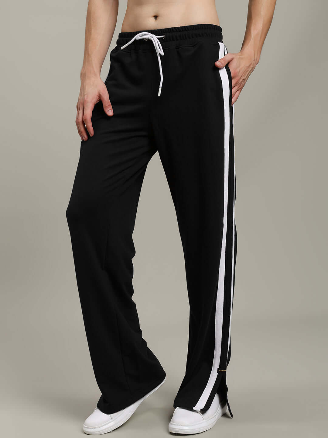 Black Moscow Relaxed Fit Joggers with white stripe detail, worn by a model, showcasing comfortable casual wear by DUDS.