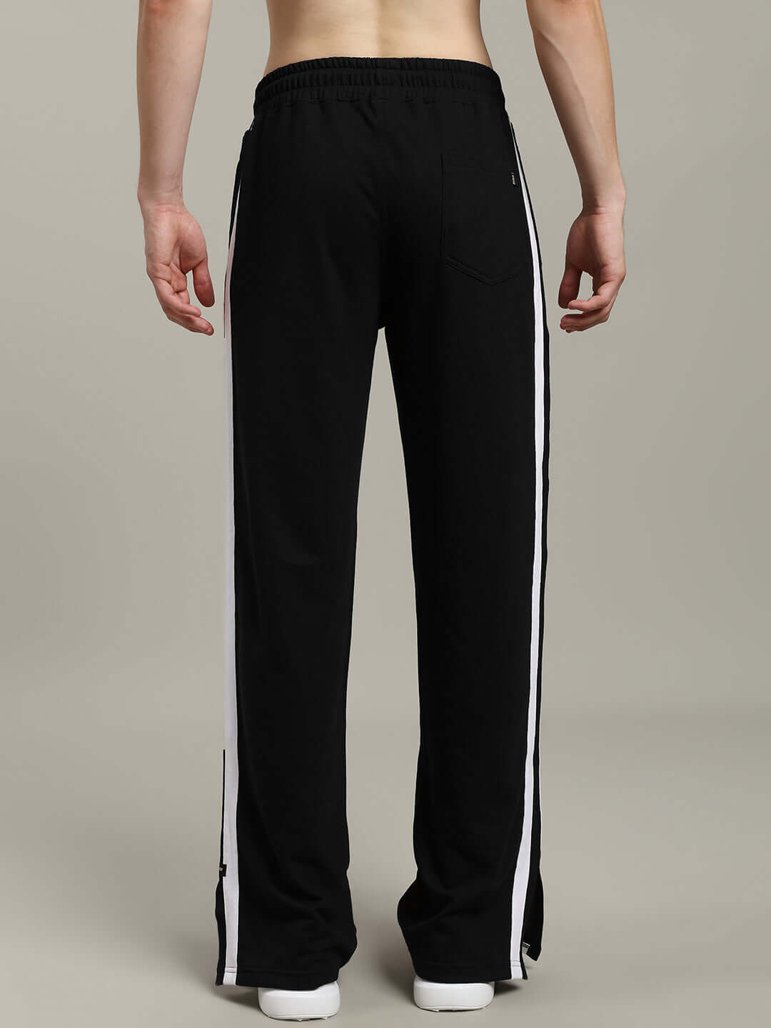 Back view of black Moscow relaxed fit joggers with white stripes and elastic waistband, designed for comfort and style.