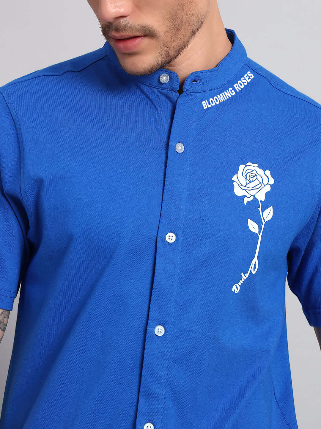 Man wearing LIMBO regular fit blue shirt with blooming roses design, made of premium French Terry cotton blend, stylish and comfortable.