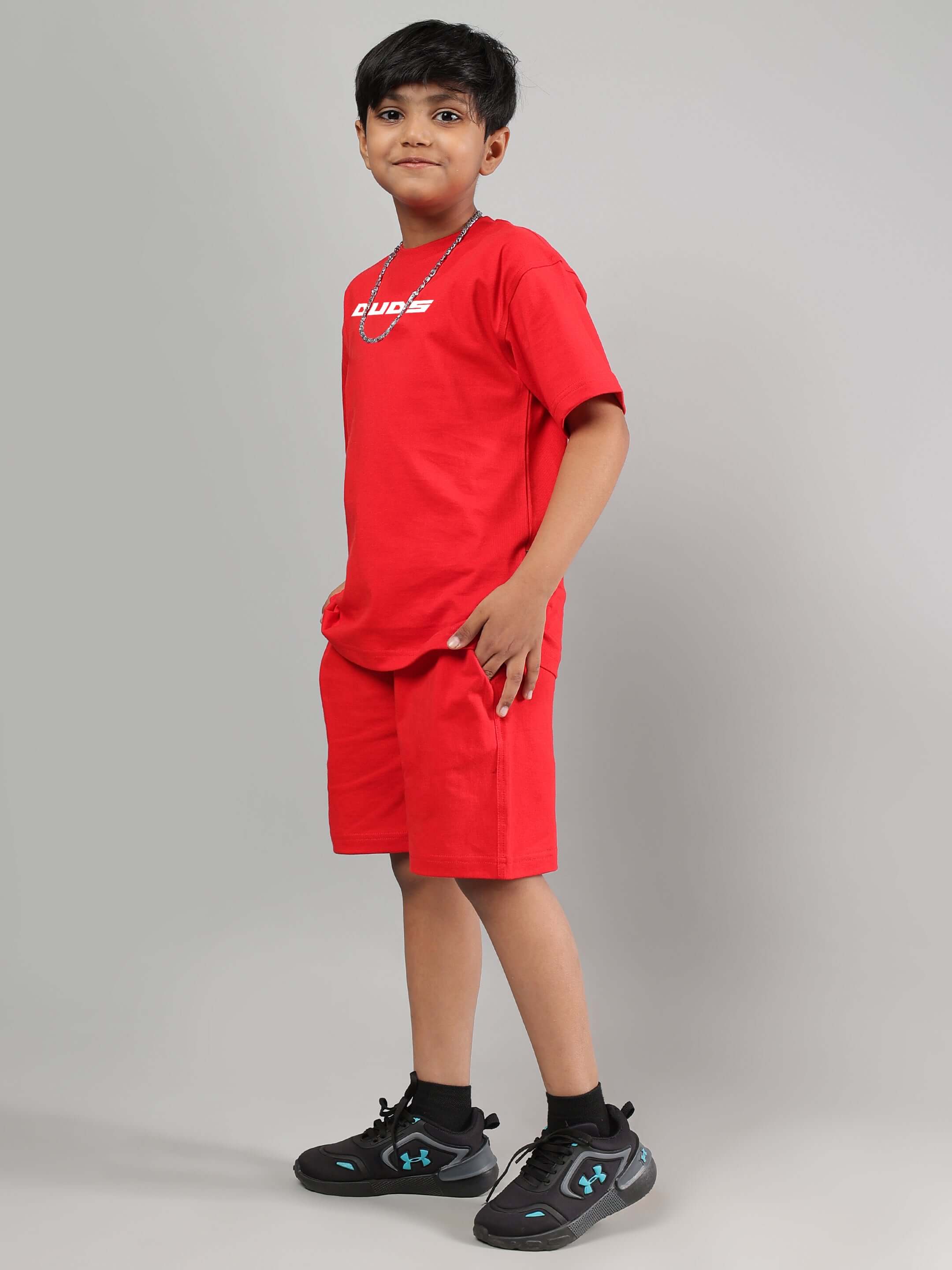 Boy wearing DUDS red co-ord set, featuring a comfortable t-shirt and matching shorts, perfect for casual outings and play.