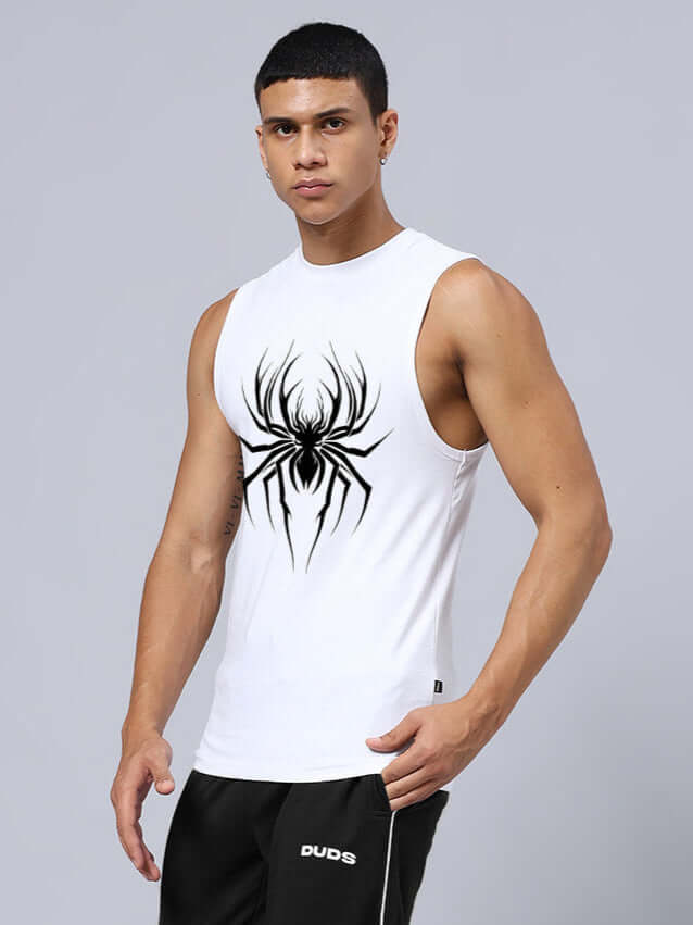 Man wearing a white sleeveless gym shirt with a bold black spider print, promoting a relaxed fit for workout sessions.