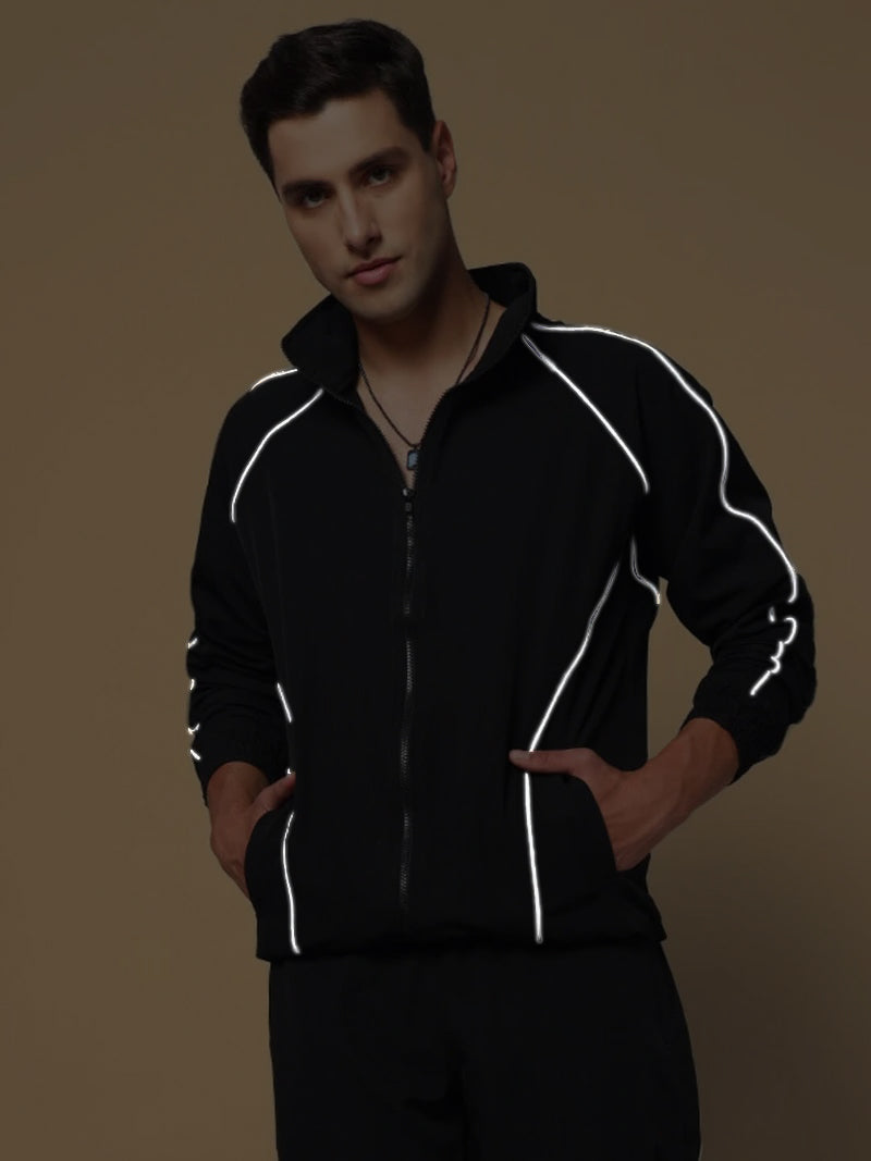 Man wearing LOCO REFLECTOR PARACHUTE SPORTS JACKET BLACK with reflective detailing against a neutral background.