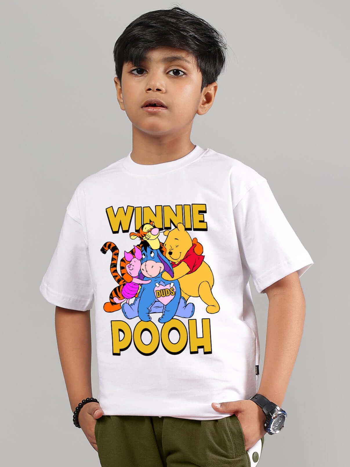 Child wearing white Winnie the Pooh T-shirt for boys and girls, featuring colorful characters from the series.