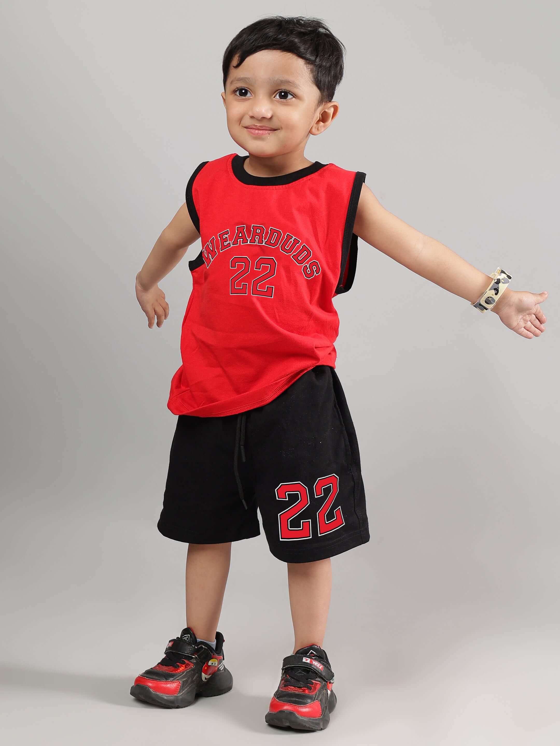 Young child wearing a stylish red Amiga t-shirt, perfect for boys and girls, made to order with care by DUDS tailors.