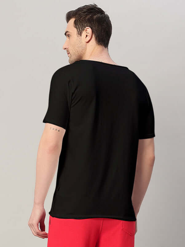 Model wearing RICKY REGULAR FIT T-SHIRT BLACK from the back view, showcasing comfortable and breathable cotton fabric.