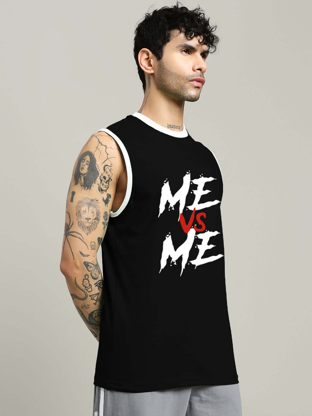 Man wearing black 'ME VS ME' gym t-shirt with custom fit option available for prepaid orders.