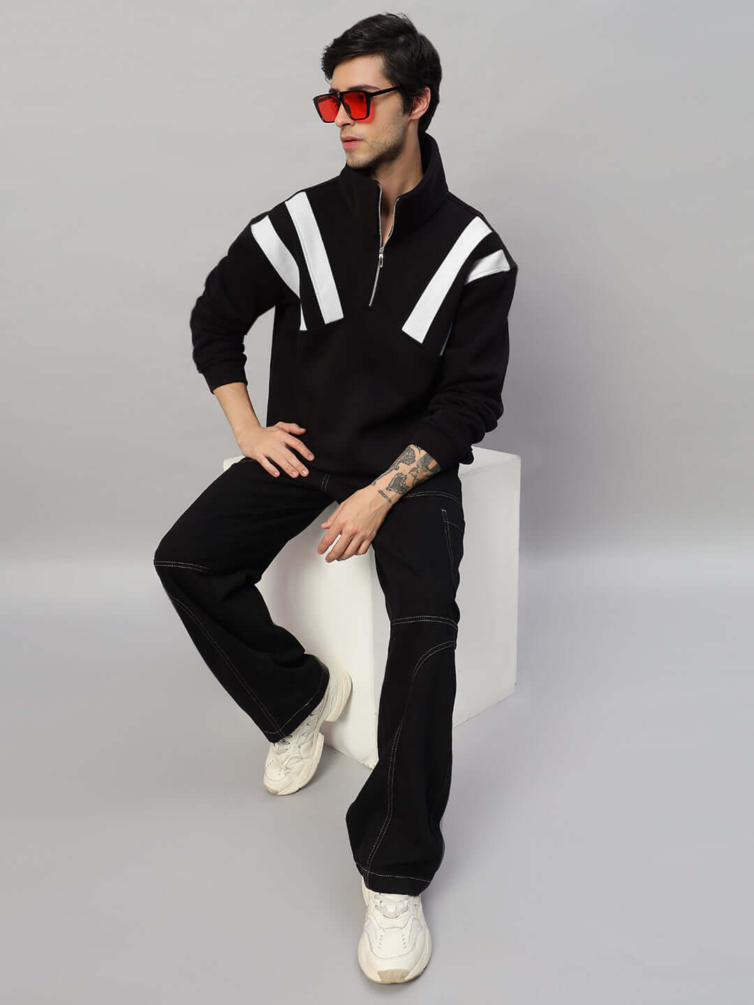 Model wearing Crossbar Fleece Colorblock Jacket in black and white, showcasing modern design and athletic style.