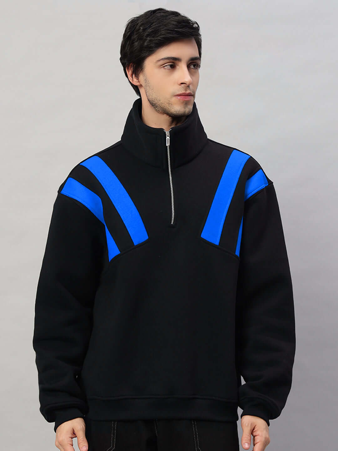 Man wearing Crossbar Fleece Colorblock Jacket in black and royal blue, featuring a modern design with zip-up collar.