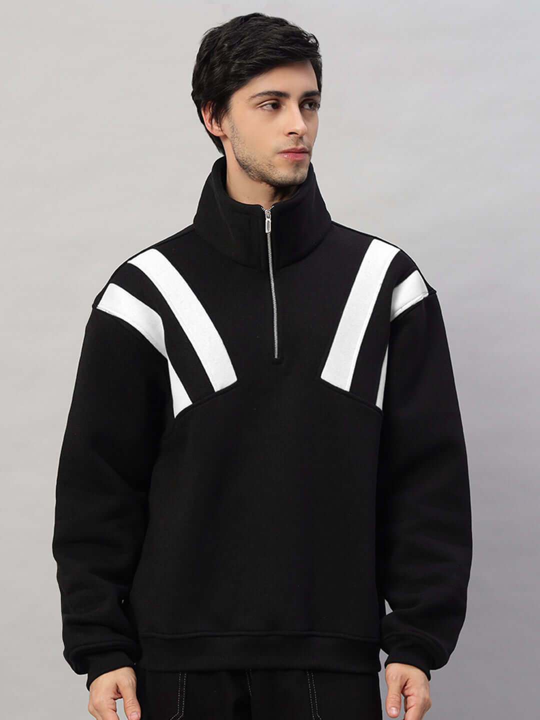 Black and white colorblock fleece jacket with zip collar, worn by a model. Stylish and warm winter outerwear.