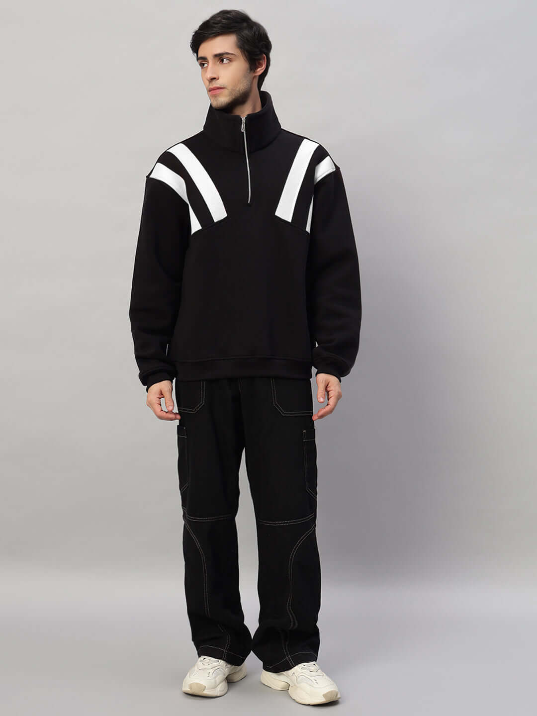 Black and white crossbar fleece colorblock jacket worn by a model, showcasing modern design and comfort.