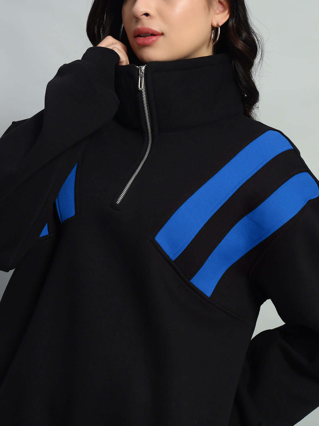 Black and blue women's colorblock fleece jacket with a crossbar design and zip-up collar.
