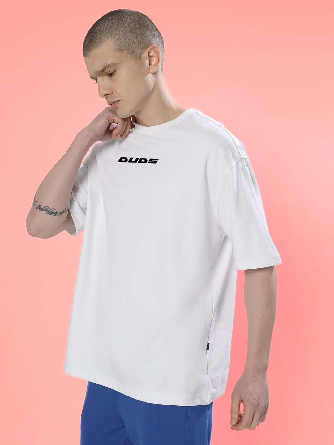 THINK HIGHER OVER-SIZED T-SHIRT WHITE, premium cotton blend, model wears white oversized t-shirt with "Dudes" text on front.