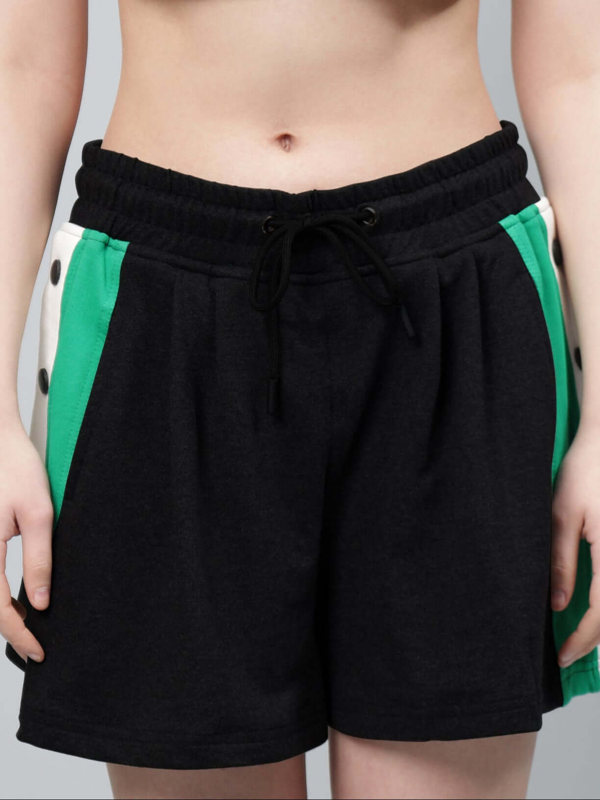 Black women's Sammie shorts with elastic waistband and green side accents, customizable fit available for prepaid orders.