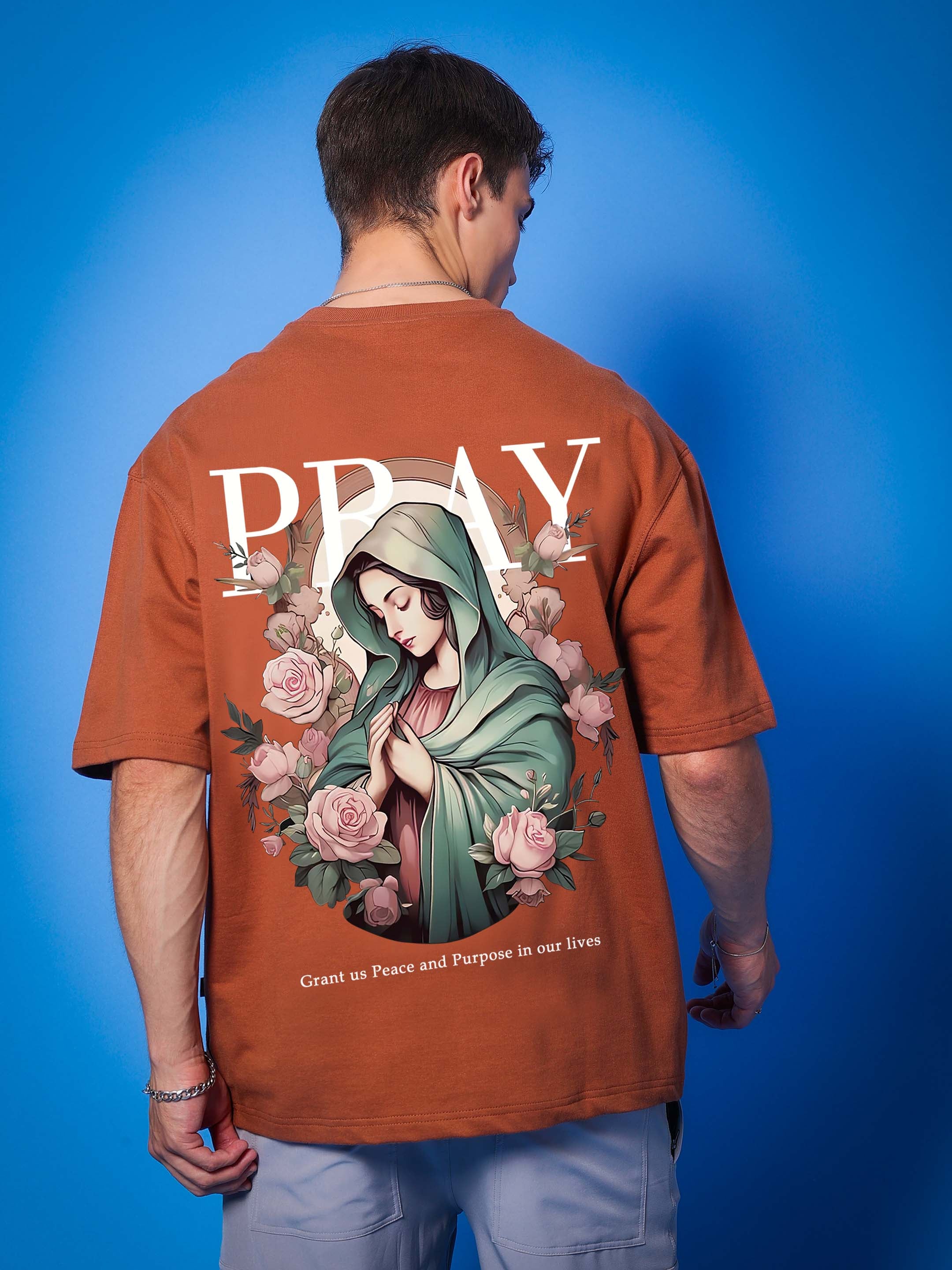 Back view of PRAY OVER-SIZED COTTON T-SHIRT BROWN with graphic design and text