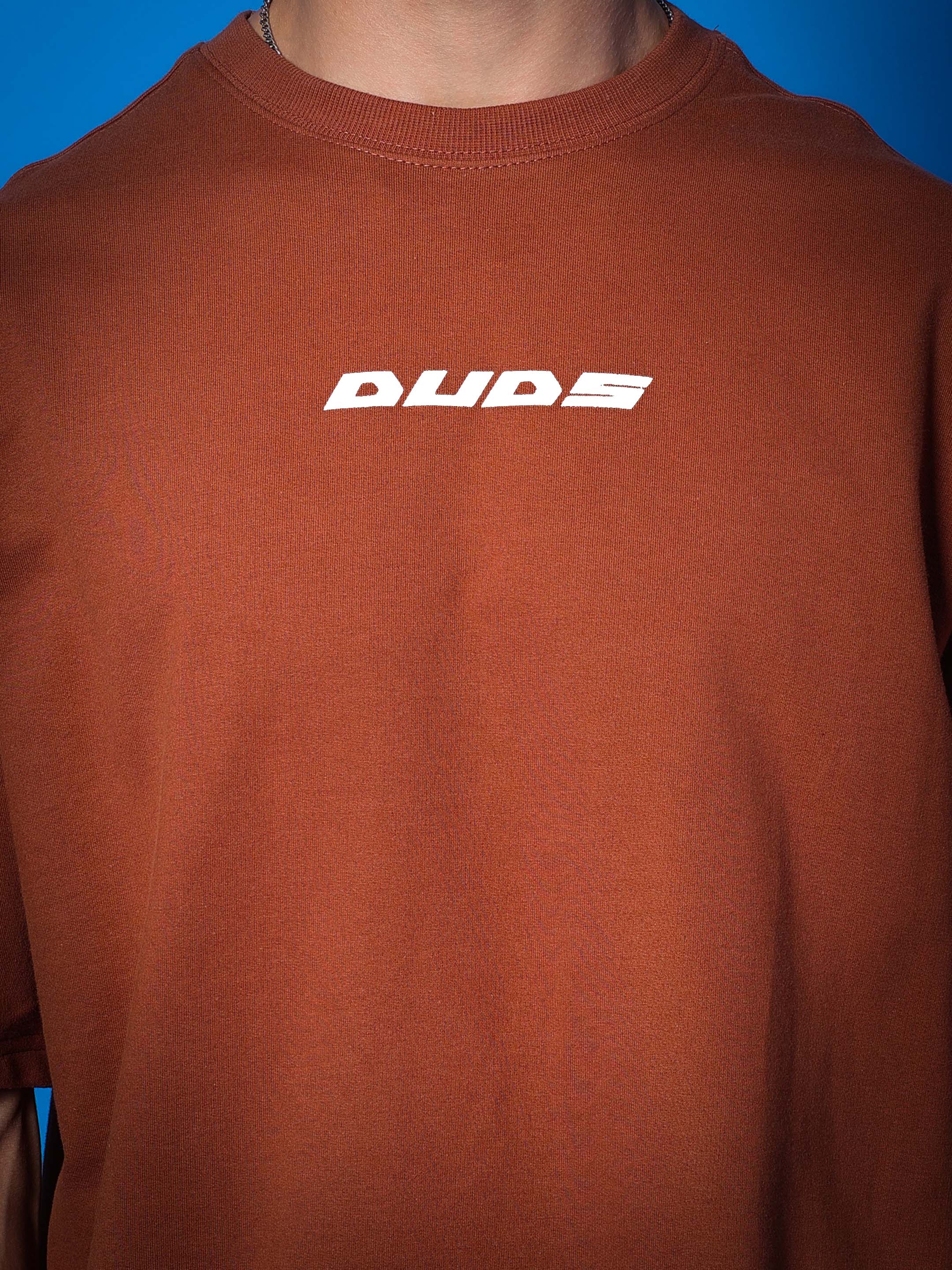 Model wearing PRAY OVER-SIZED COTTON T-SHIRT BROWN, featuring premium heavy gauge fabric with 97% cotton and 3% elastane.