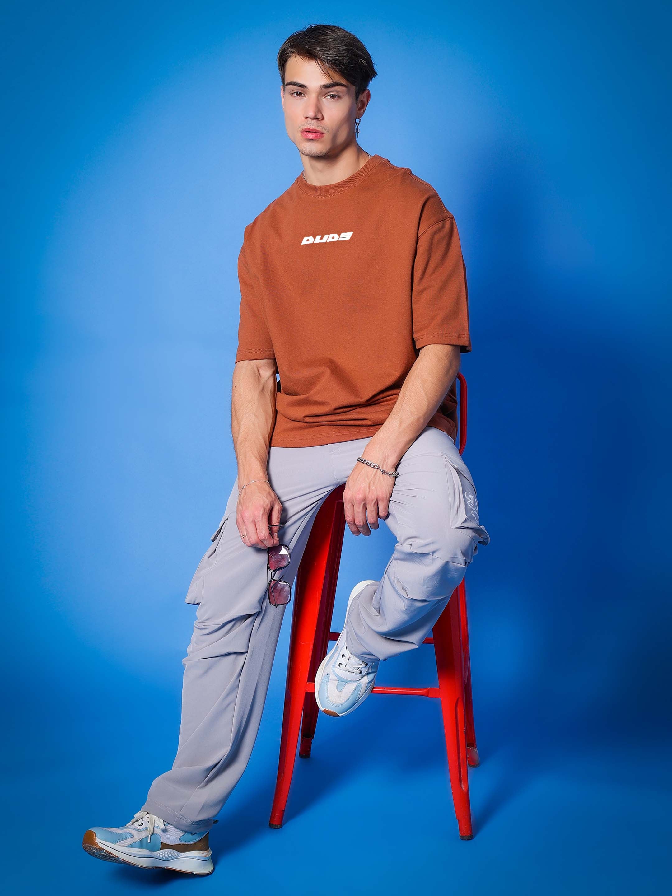 Model wearing PRAY OVER-SIZED COTTON T-SHIRT BROWN, casual style