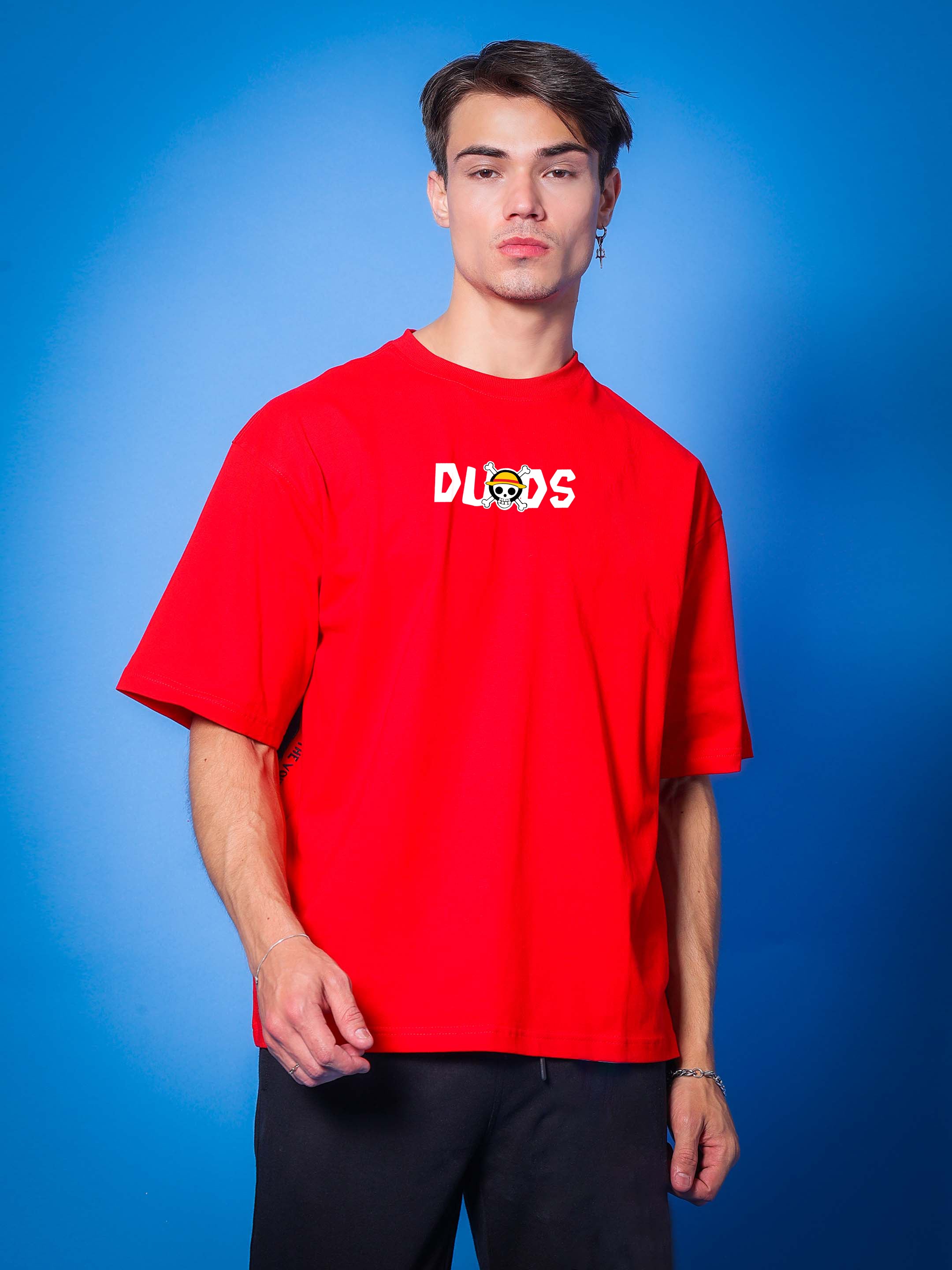 Model wearing ONE PIECE OVER-SIZED T-SHIRT RED by DUDS with blue background