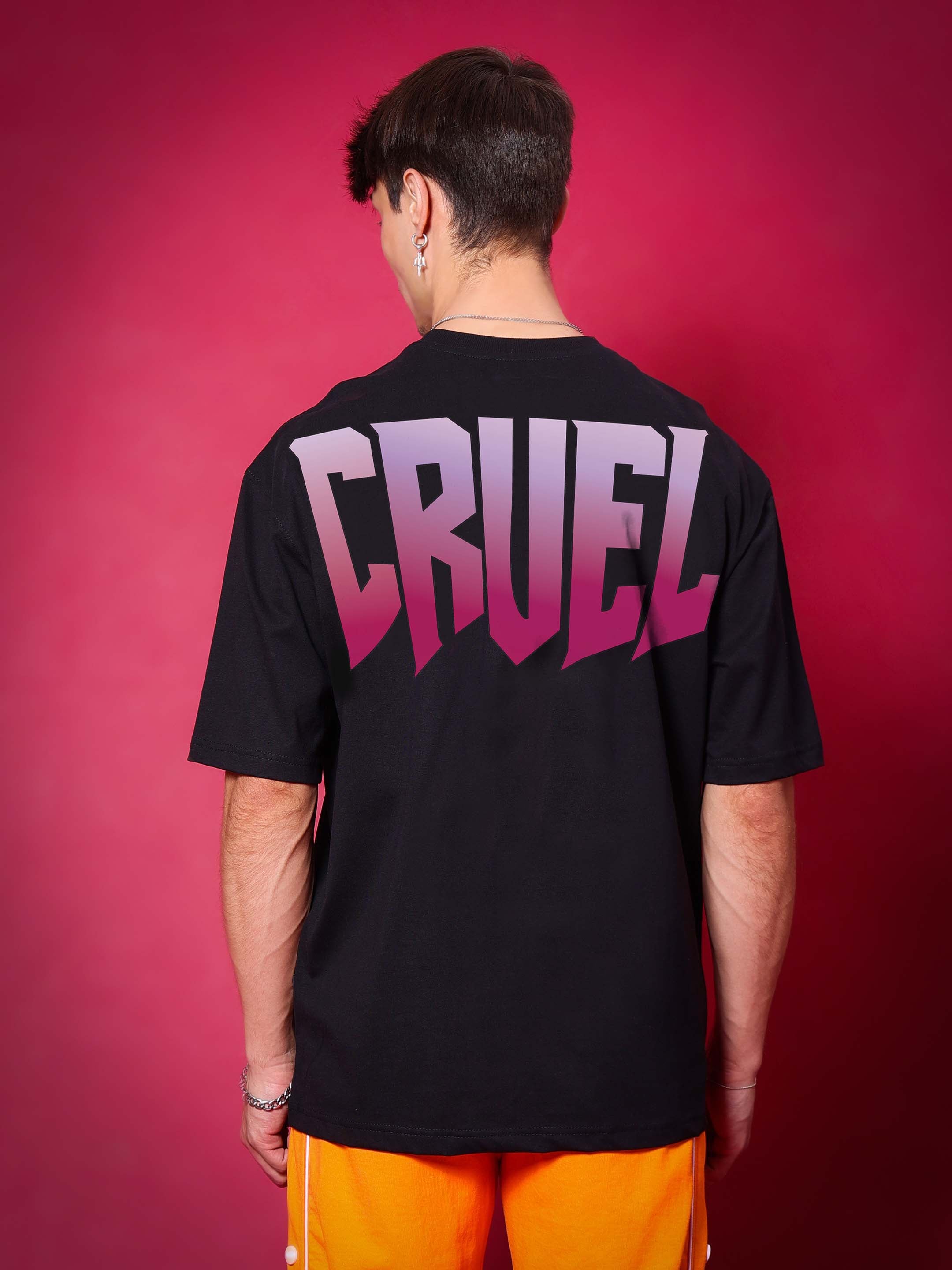 Back view of CRUEL OVER-SIZED T-SHIRT BLACK with CRUEL text in purple gradient.