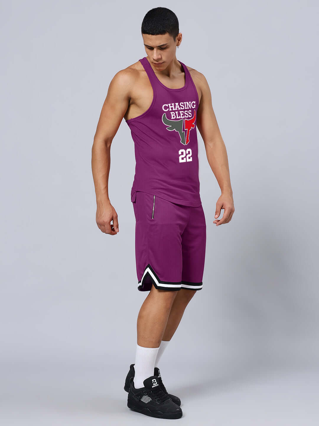 Athletic man wearing CHASING BLESS PRINTED GYM CO-ORD SET PURPLE, showing side view.