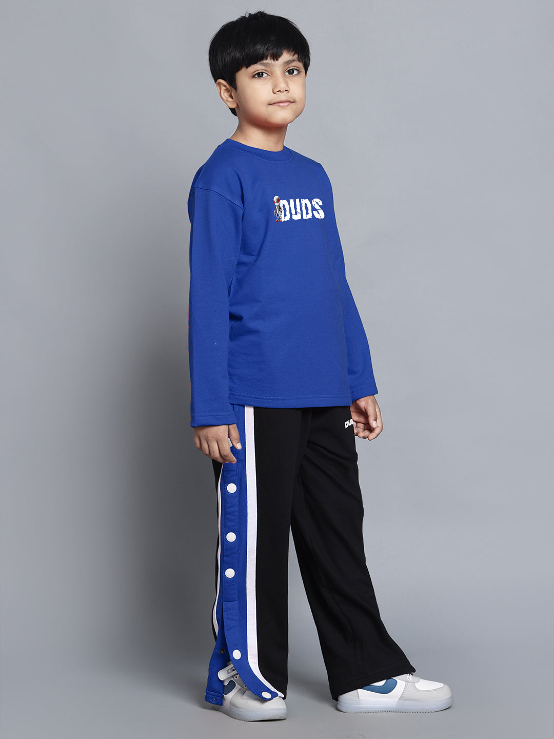 Boy wearing SPIDERROBO COTTON CO-ORD FOR BOYS AND GIRLS BLUE BLACK set, featuring blue top and black pants with button details.