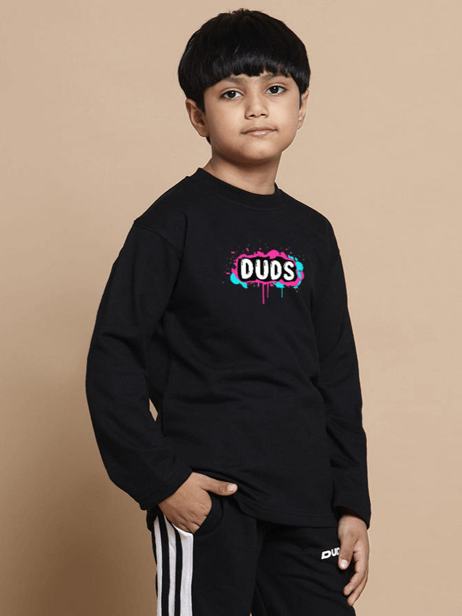 Child wearing black unisex sweatshirt with colorful "DUOS" logo, made from premium cotton fabric, suitable for boys and girls.