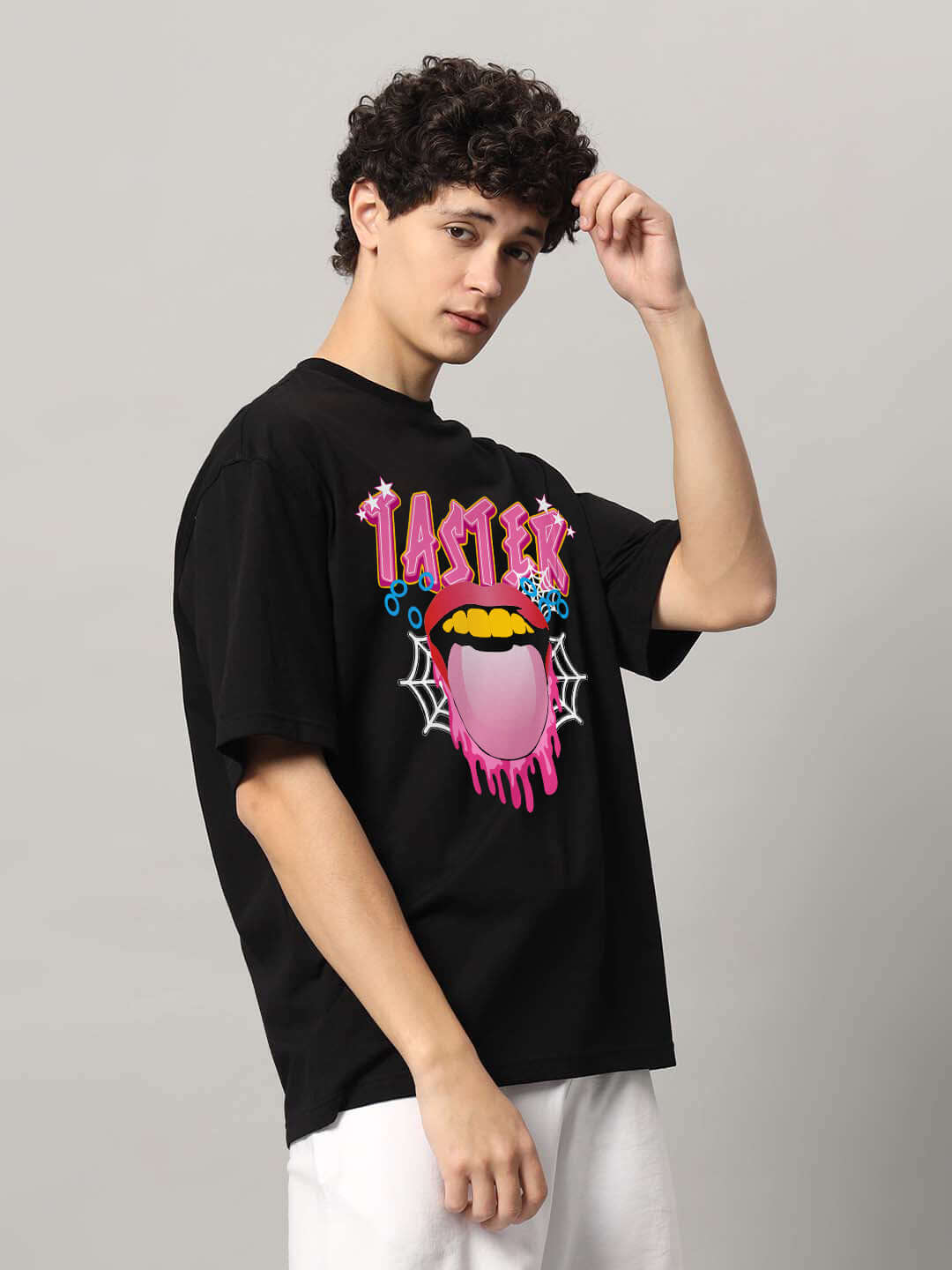 Man wearing TASTER OVER-SIZED T-SHIRT BLACK with colorful graphic. Custom fit option available for prepaid orders through size tab.