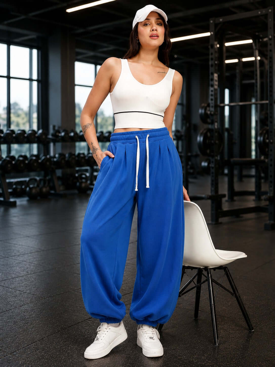 WOMEN COOLFIT BAGGY LOOSE FIT JOGGER BLUE worn by a model in a gym setting, showcasing a stylish athletic look.