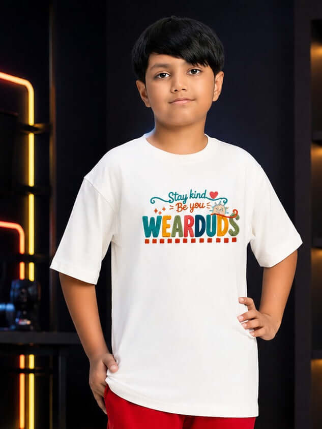 STAY KIND GRAPHIC T-SHIRT FOR BOYS GIRLS WHITE RED worn by a boy against a stylish backdrop.