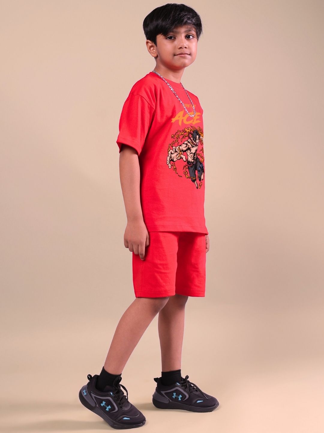Child wearing ACE co-ord set in bold red, designed for both boys and girls. Features dynamic style and comfort for a striking impression.