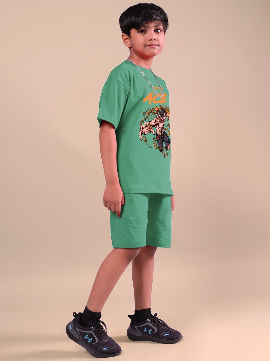 Child wearing ACE co-ord set in vibrant green, featuring a bold graphic shirt and matching shorts, ideal for boys and girls.