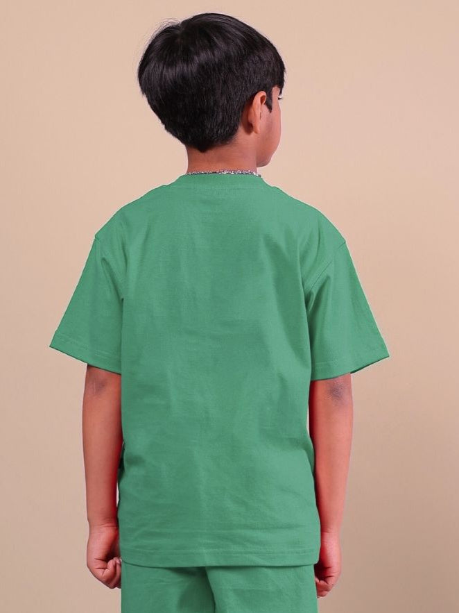 Rear view of child wearing ACE green t-shirt, designed for boys and girls, showcasing vibrant color and comfortable fit.