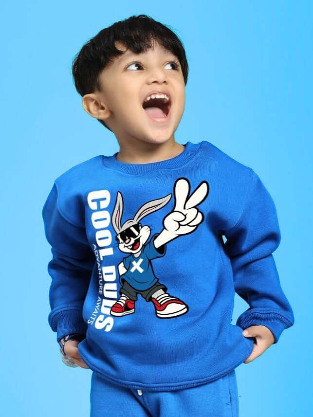 Child wearing Adventure Bunny Fleece Sweatshirt for Boys and Girls Blue, featuring cartoon bunny and "Cool Dudes" print on a blue background.