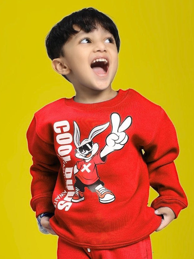 Child wearing ADVENTURE BUNNY FLEECE SWEATSHIRT FOR BOYS AND GIRLS RED with playful graphic on yellow background