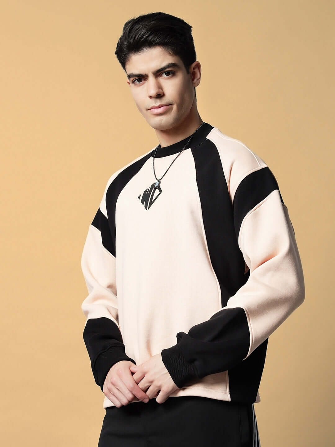 Man wearing AERO OVERSIZED FLEECE SWEATSHIRT BEIGE, a soft warm fleece with an oversized fit, perfect for layering on chilly days.