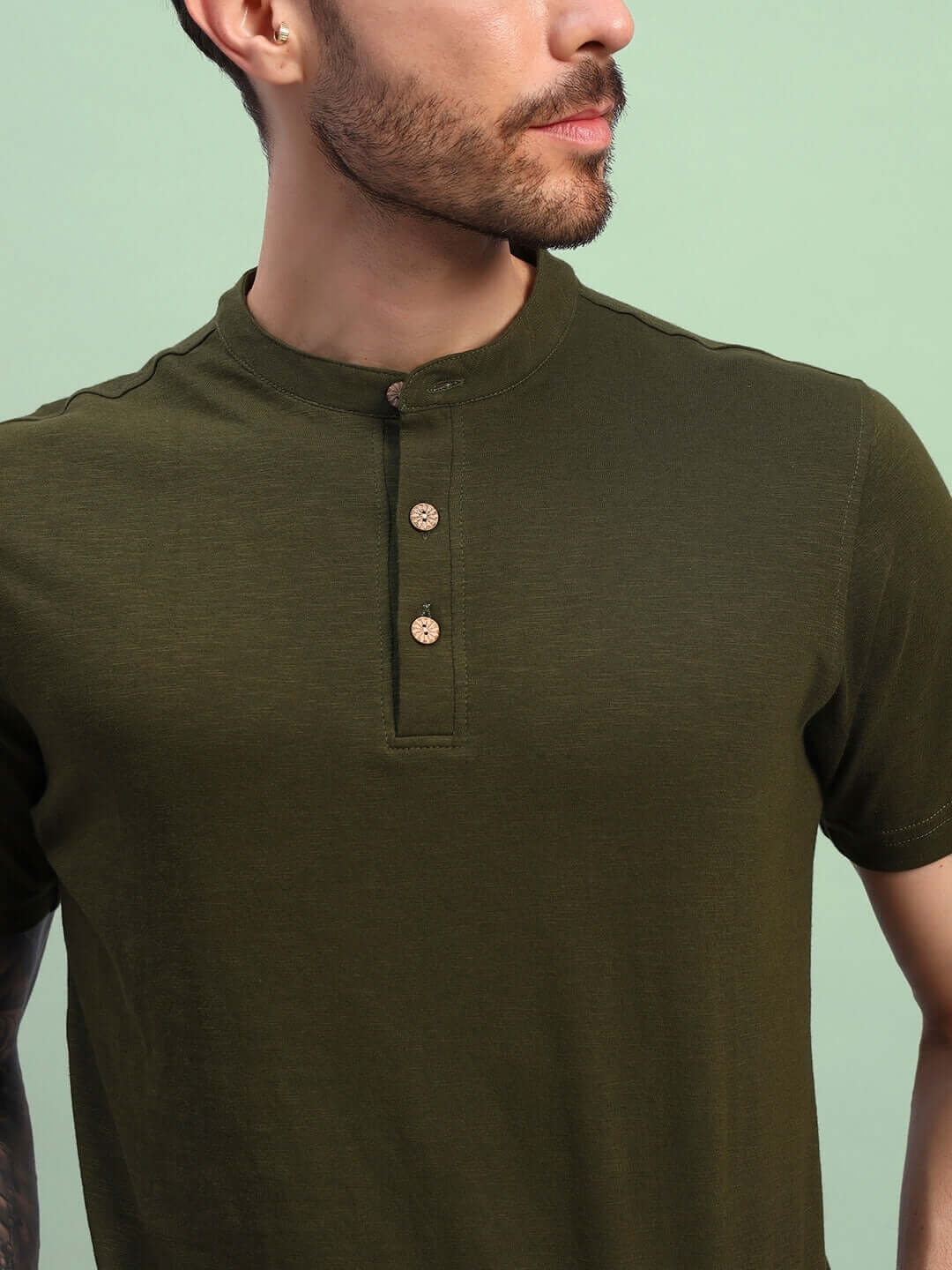Olive green regular fit t-shirt in premium cotton slub fabric, featuring wooden buttons, perfect for casual wear.