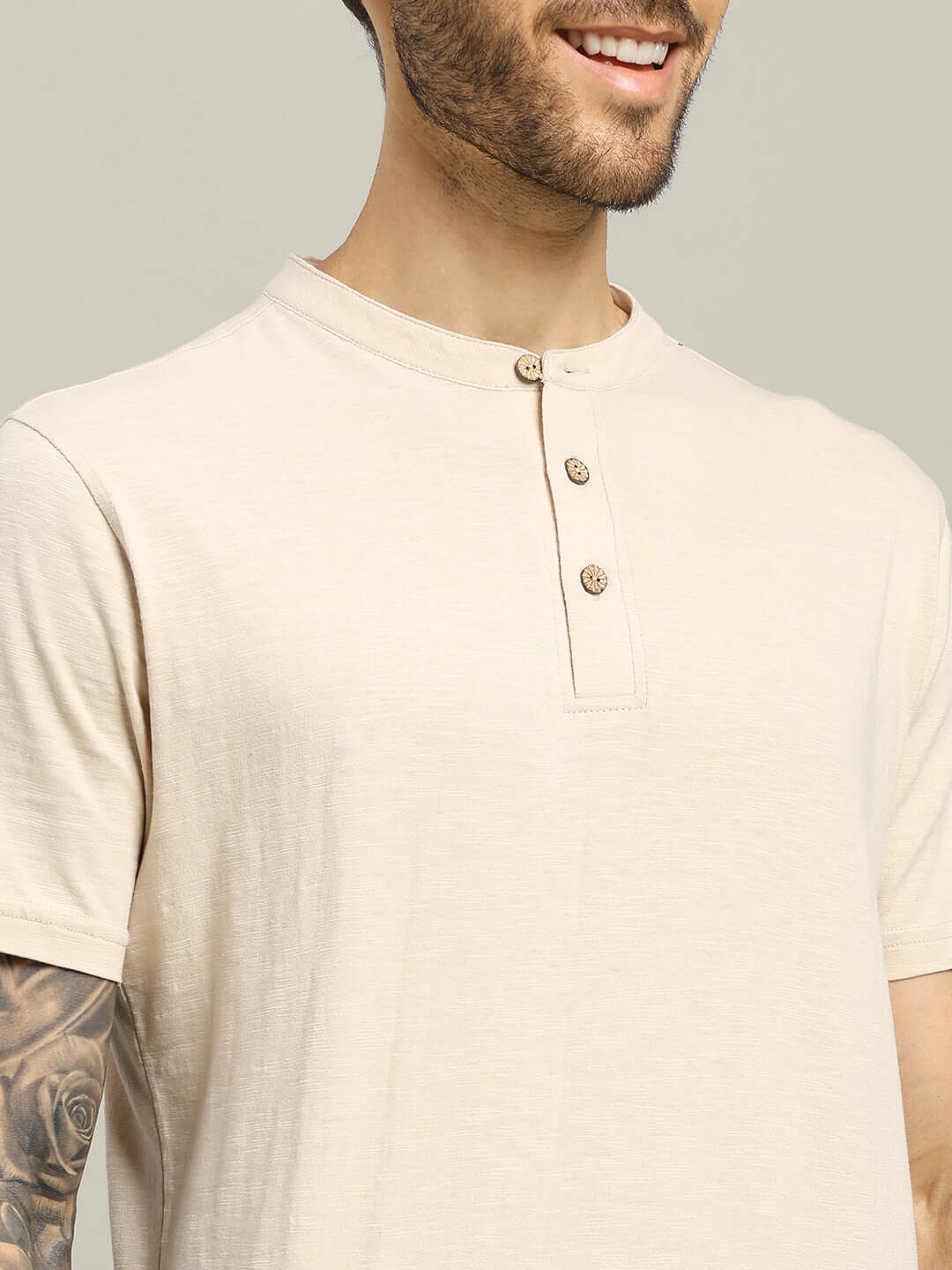 Man wearing ALBET REGULAR FIT T-SHIRT BEIGE, featuring a soft, breathable cotton fabric with a versatile, neutral beige color.
