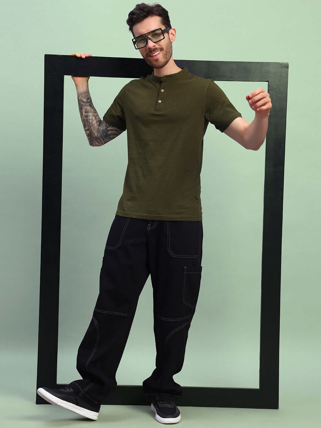 Model wearing olive green Albet Regular Fit T-Shirt made from premium heavy cotton slub fabric, styled casually with black pants.
