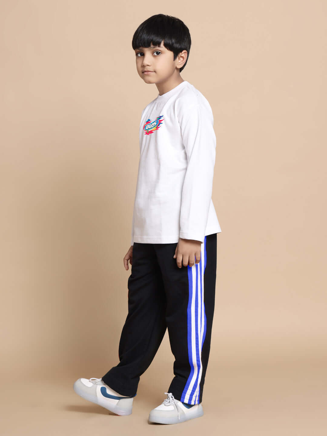 Child wearing white-black alien-themed co-ord outfit with blue stripe, designed for boys and girls. Comfortable casual wear by DUDS.