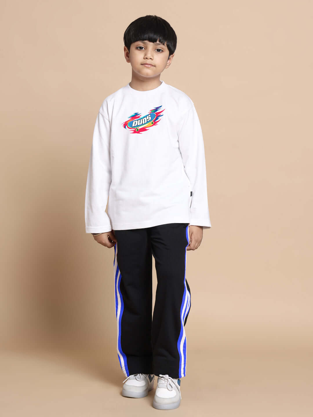 Child wearing white-black ALIEN CO-ORD from DUDS, featuring comfortable long sleeves and blue stripe detail pants, suitable for boys and girls.