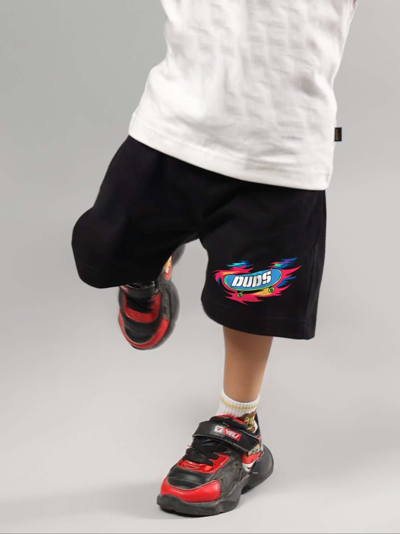 Child wearing black alien print shorts by DUDS; comfortable fit for boys and girls; customizable size option available.