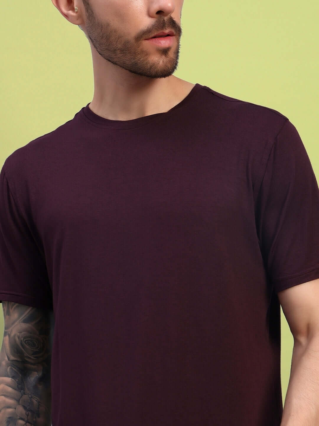 Man wearing maroon AMBLE T-shirt made from premium heavy gauge modal fabric, showcasing casual style. Cold machine washable, made in India.