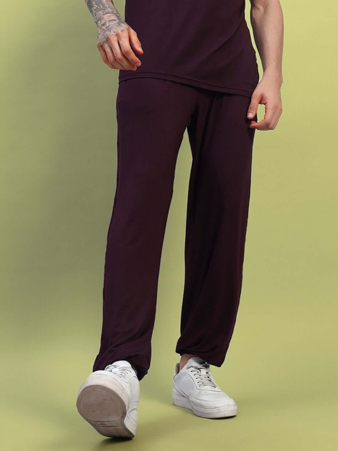 Person wearing AMBLE RELAXED FIT JOGGER MAROON with sneakers, showcasing comfort and style.