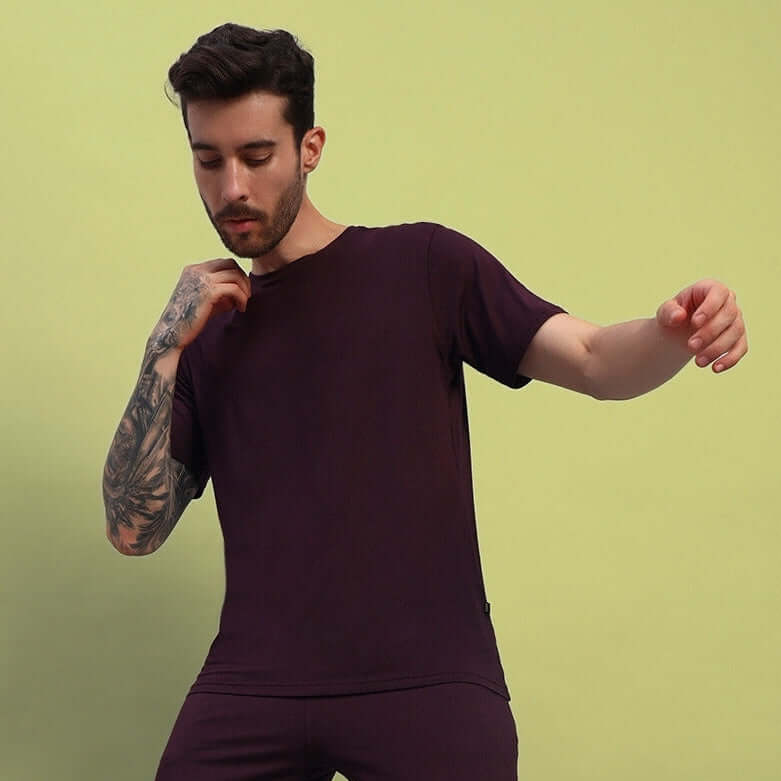 Model wearing maroon AMBLE T-shirt made from premium heavy gauge modal fabric, showcasing a relaxed fit. Manufactured in India by Color By Colours.