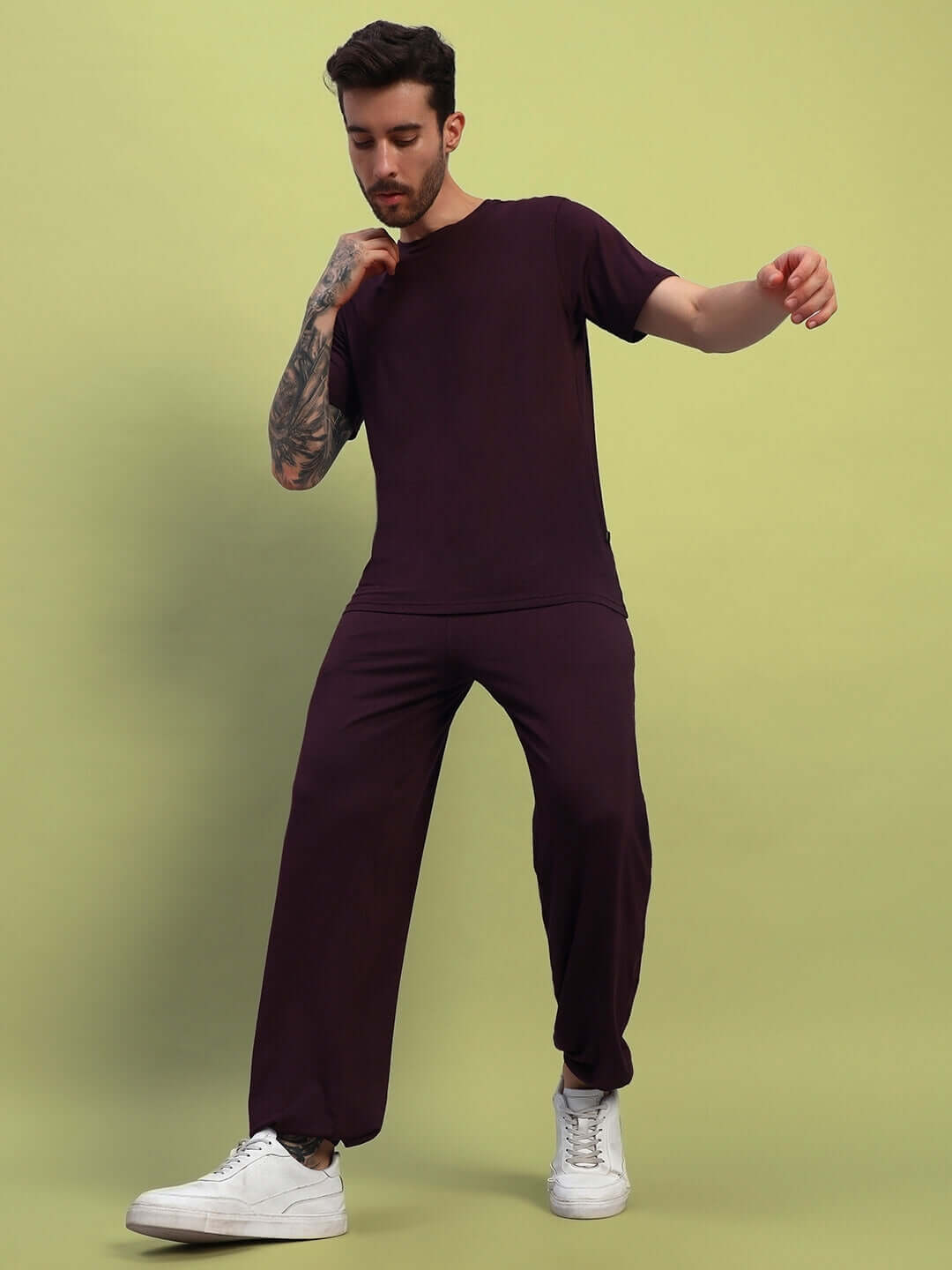Model wearing AMBLE maroon t-shirt, premium heavy gauge modal fabric, bio-washed, stylish casual wear.