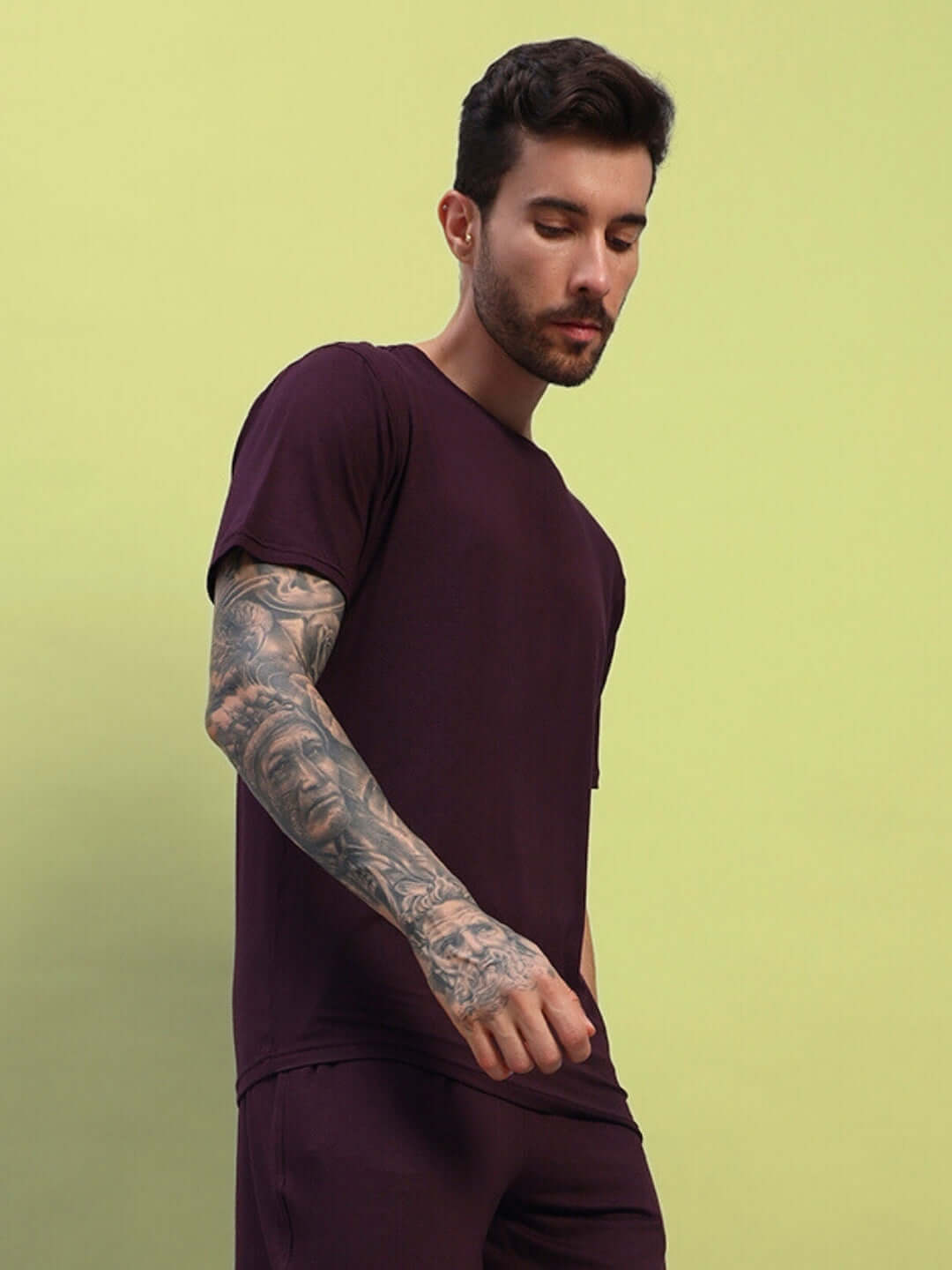 Model wearing AMBLE maroon t-shirt featuring premium heavy gauge modal fabric, bio-washed, made in India.