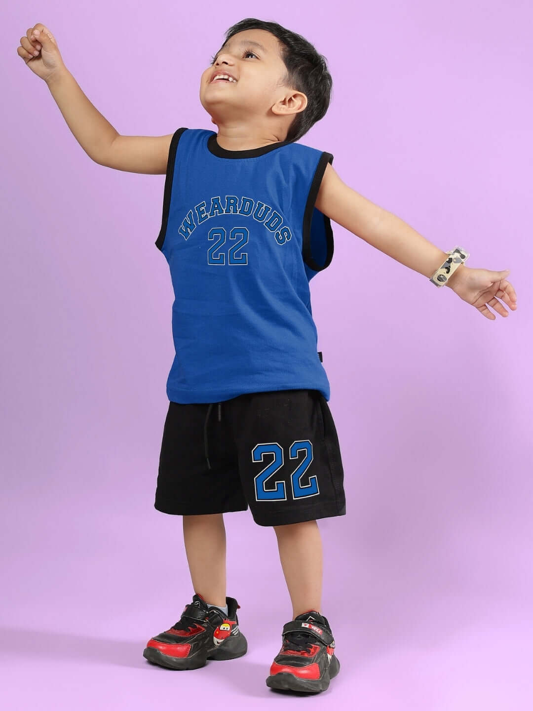 Child wearing AMIGA CO-ORD FOR BOYS & GIRLS BLUE BLACK with sporty top and shorts, showing off trendy style for all occasions.