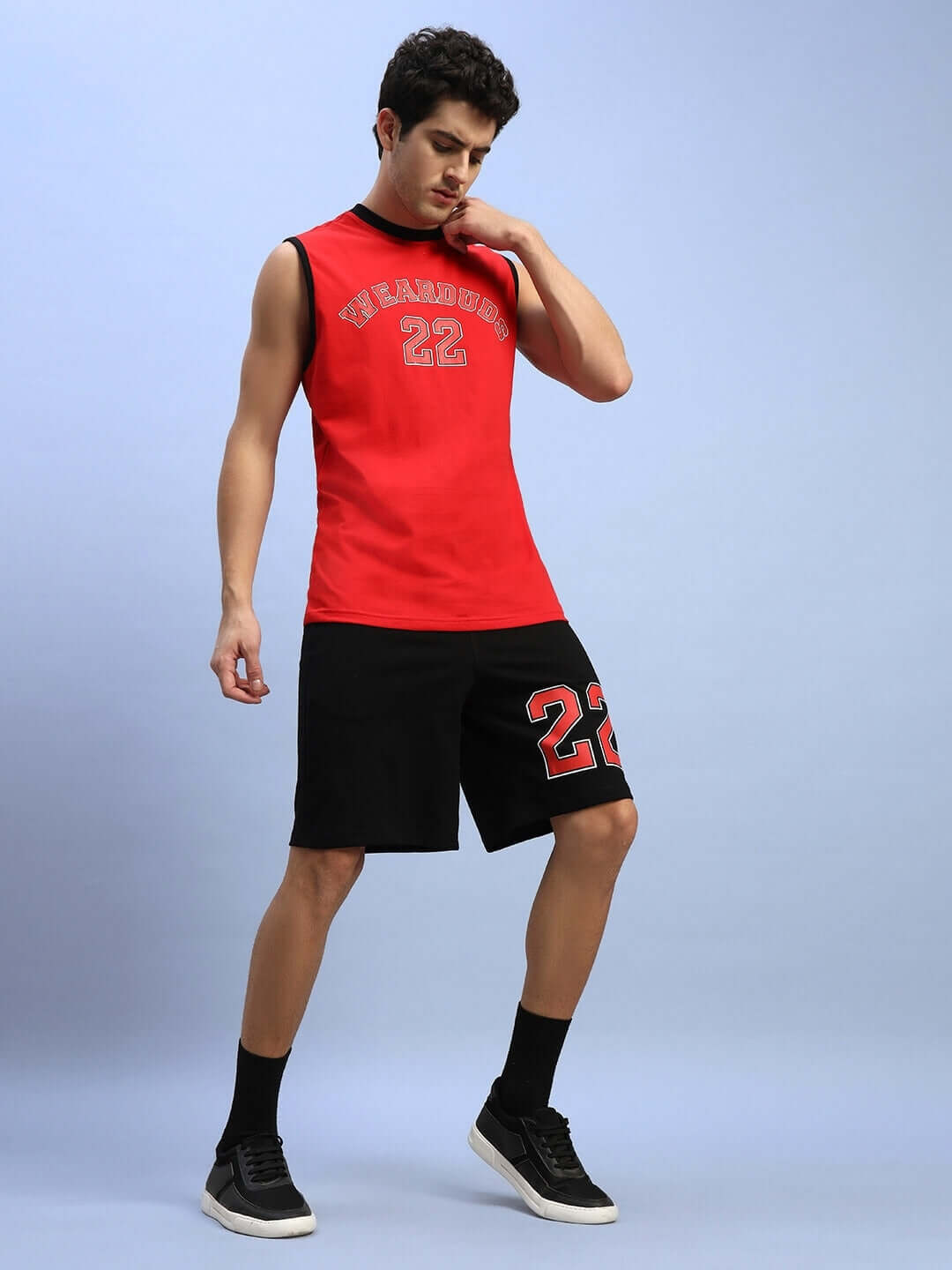 Man wearing AMIGA GYM CO-ORD SET RED-BLACK, featuring a sleeveless red top and black shorts, made of 100% cotton.