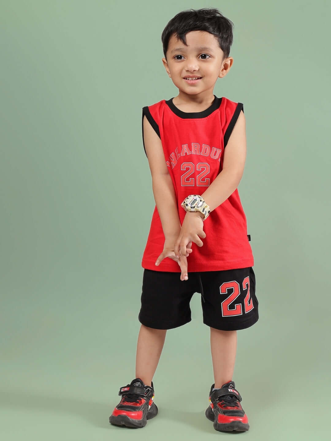 Child wearing AMIGA SHORTS FOR BOYS & GIRLS BLACK RED, paired with a matching red top, showcasing comfortable and stylish kidswear.