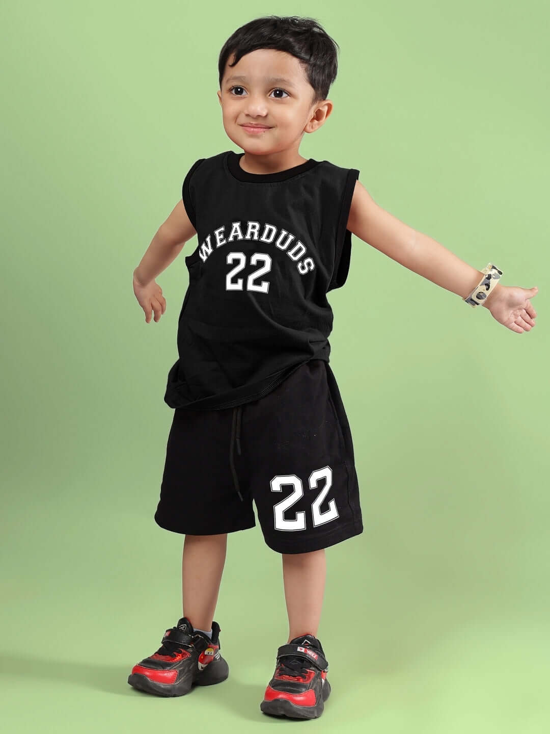 Young child wearing AMIGA CO-ORD FOR BOYS & GIRLS BLACK with 'WEARDUDS 22' design on black background.